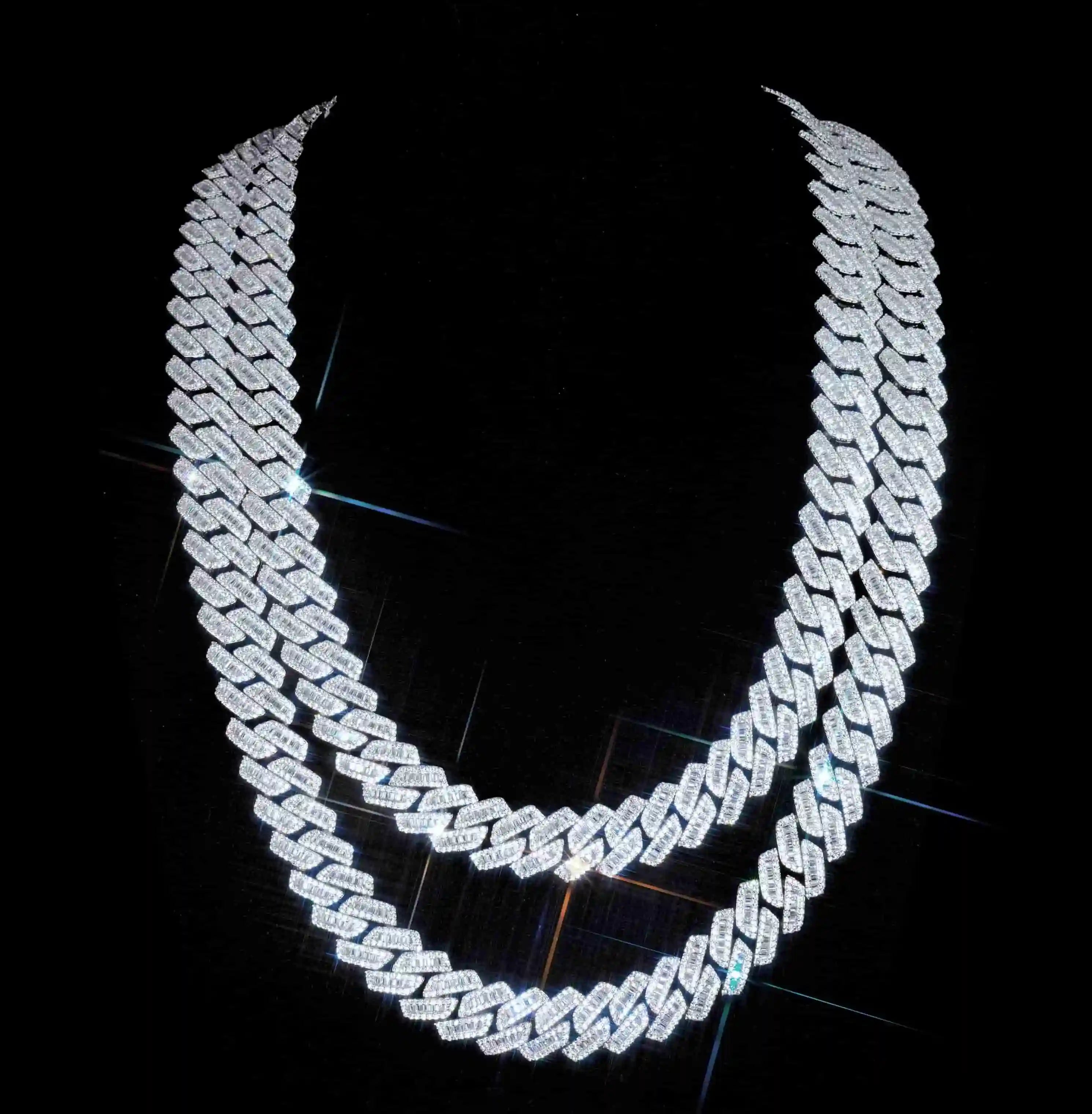 Upgrade your style with our new 13mm curved prong Cuban chain, featuring hand-set baguette stones for a bold and flawless look. Available in multiple lengths and crafted with VVS simulated diamonds, our chain is perfect for any occasion. Package includes chain, dust bag, gift box, jewelry cloth, and warranty card.